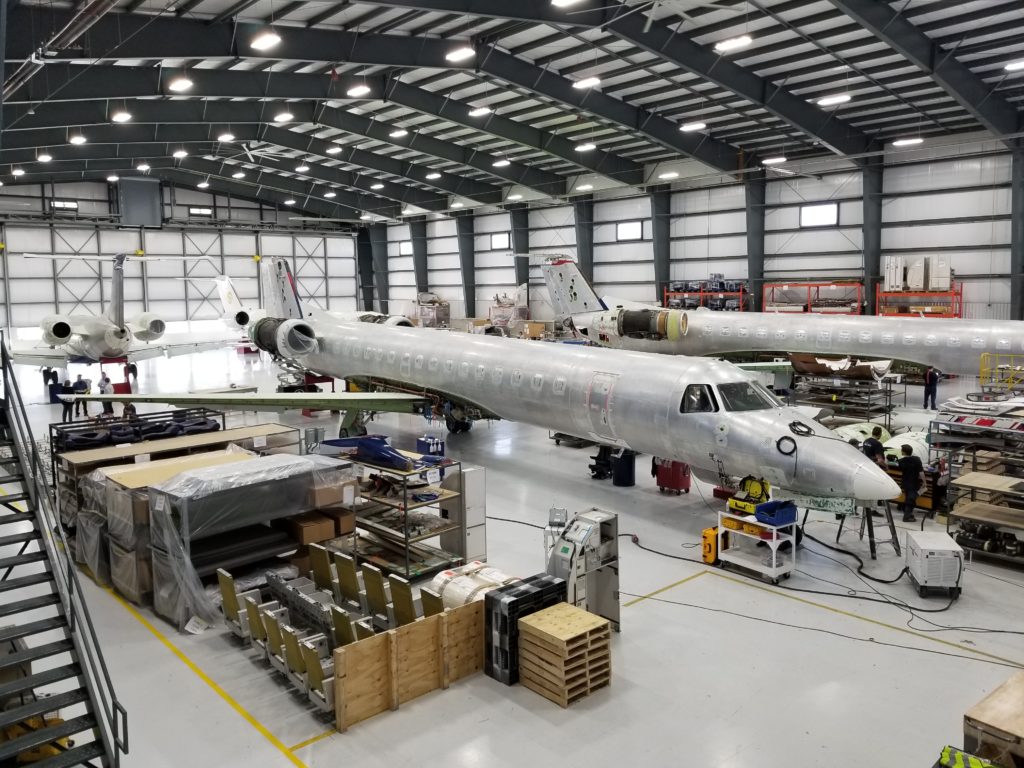 aircraft being worked on in maintenance hanger with no paint