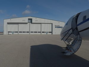 new united goderich plane infront of a hangar