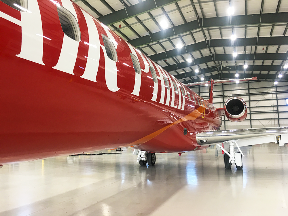 close up of red exterior paint with white text for embraer erj145