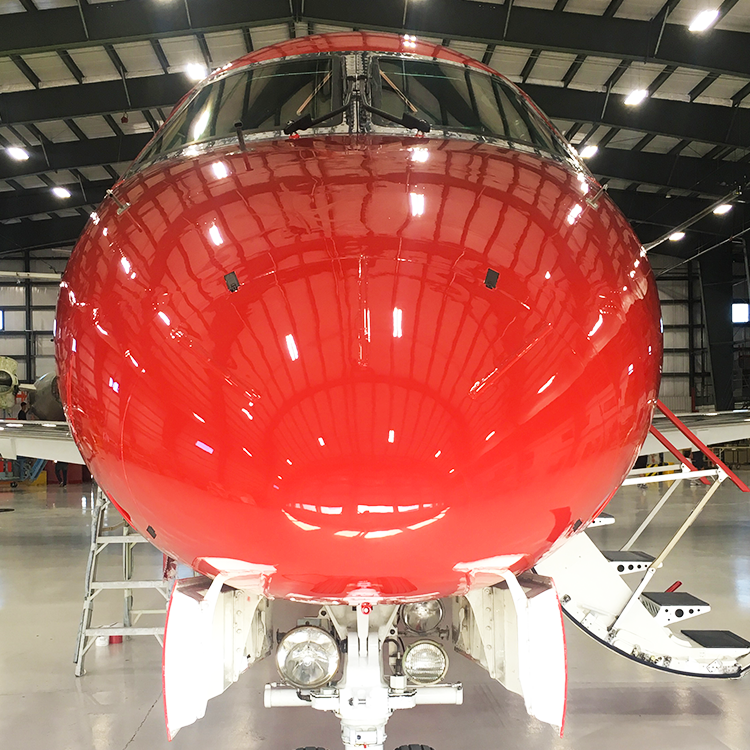 nose of red embraer erj145 inside new united goderich hangar