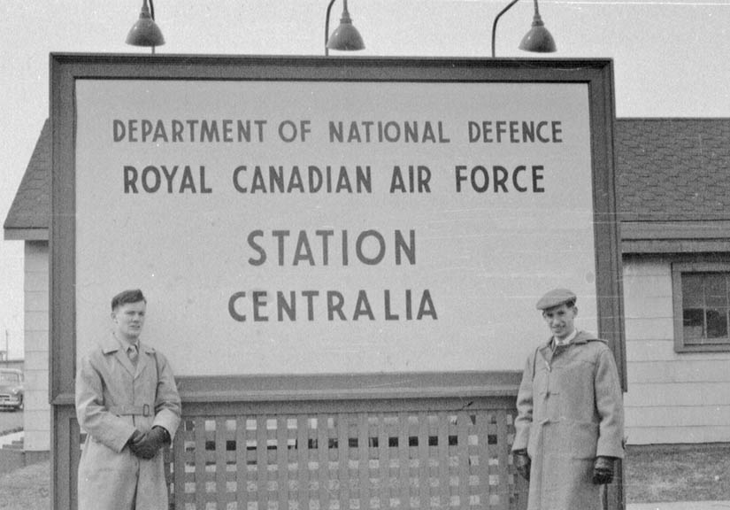 two men outside rcaf station centralia sign