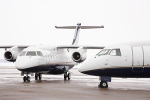 two white dornier aircraft outside on hangar ramp
