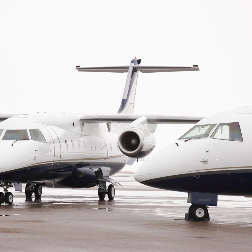two white dornier aircraft outside on hangar ramp two white dornier aircraft outside on hangar ramp